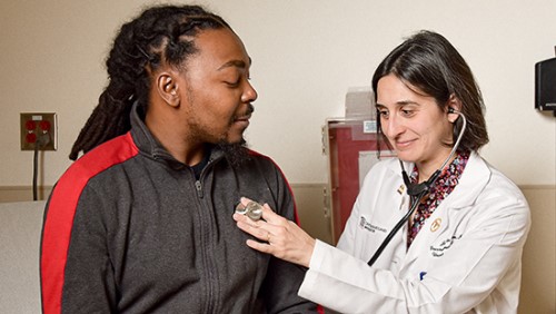Hematologist Jennie Law interactis with a sickle cell patient