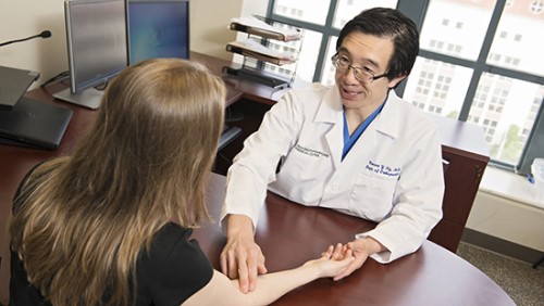 Dr. Vincent Ng meets with a patient